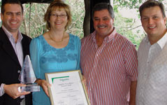 Presentation of the award by Ernie Smith (right) and Stephanie Podmore from Schneider/Conlog (left centre) to Riaan van Kooten (left) and Andre du Preez from AAD (right centre)
